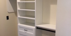 Custom walk-in closet system with oil-rubbed bronze hardware