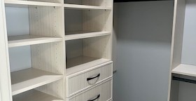 Closet with pull-out ironing board installed by Organized Options