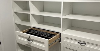 Walk-in closet system with white finish and Allegra drawer fronts