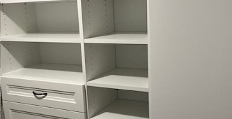 Walk-in closet system with white finish and Allegra drawer fronts