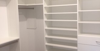 Walk-in closet with drawers, shoe tower and upper storage