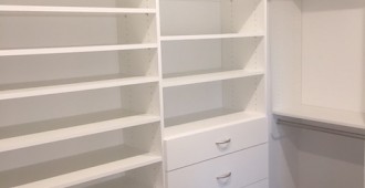 Walk-in closet with drawers, shoe tower and upper storage