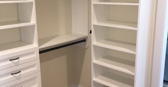 Custom walk-in closet system with oil-rubbed bronze hardware
