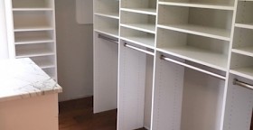 Walk-in closet with sloped ceiling and Island